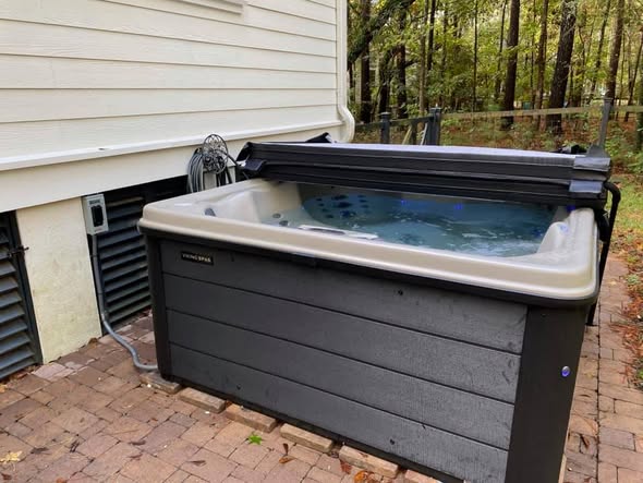 Hot tub installed by Comfort Daniel Island on a backyard paver patio in Charleston, SC