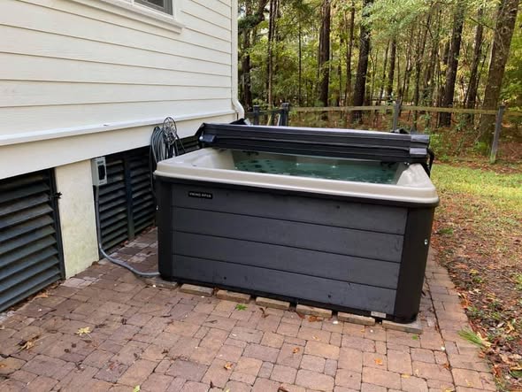 Angled view of a completed backyard hot tub installation