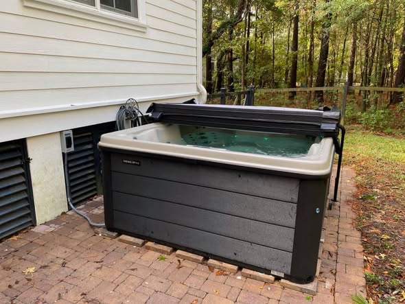 Hot tub with cover open, installed and filled, ready to enjoy