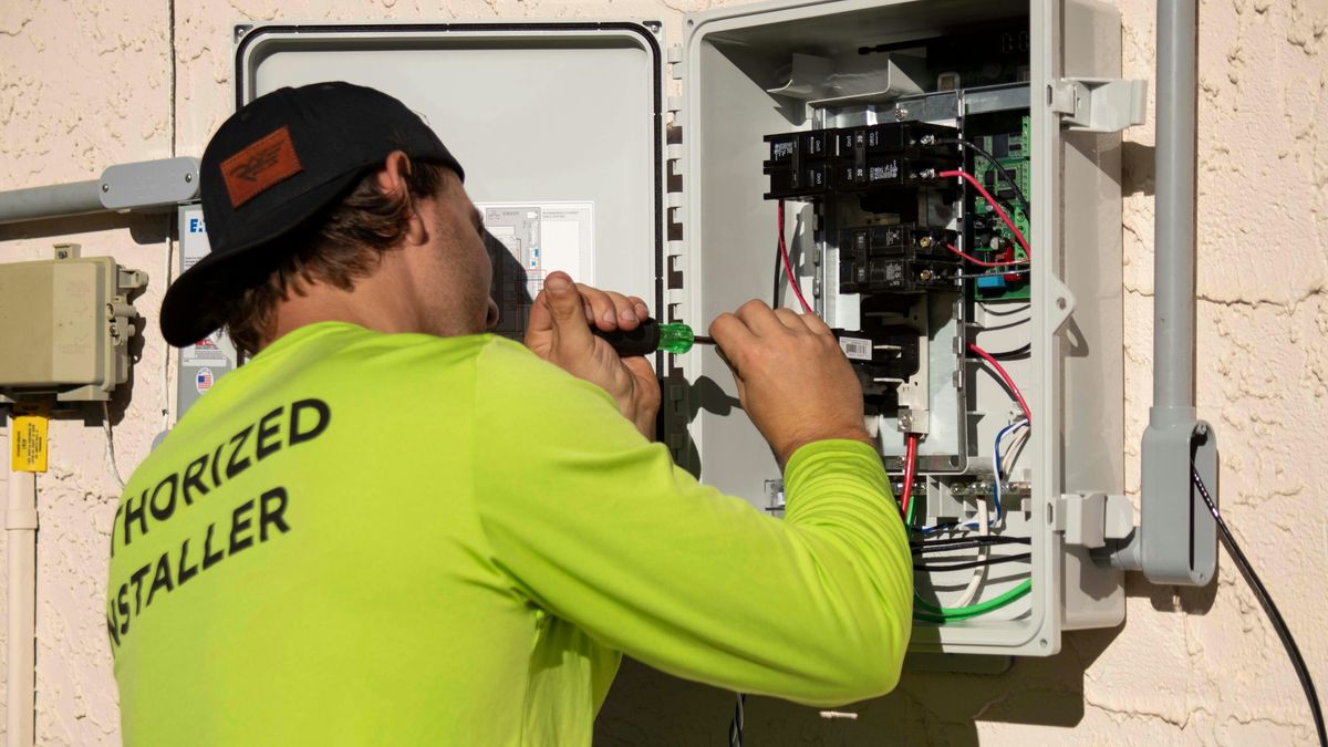 Authorized HVAC technician working on electrical panel